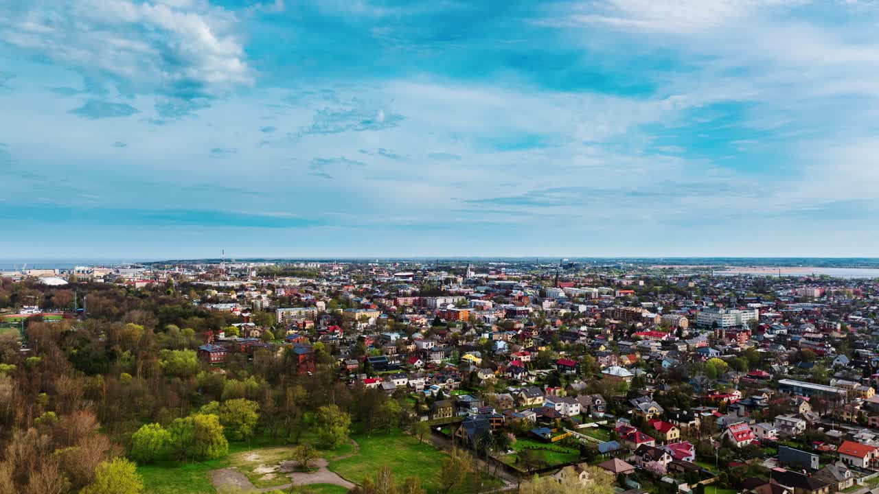 Smooth hyperlapse colorful Liepāja houses blooming in vibrant springtime scenery
