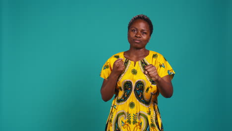 Strong-rebel-woman-posing-with-clenched-fists-in-studio