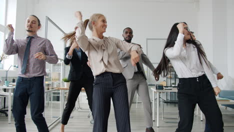happy business team dancing in office