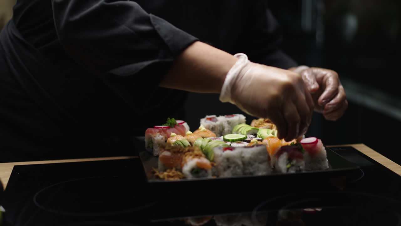 Chef arranging sushi on a plate