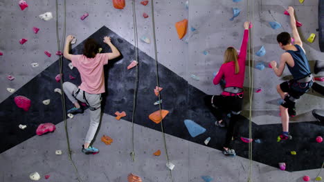 teenage boys and girl climbing indoors