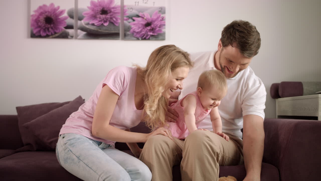 Parents playing with baby at home