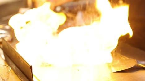 chef performs a flaming cooking demonstration.