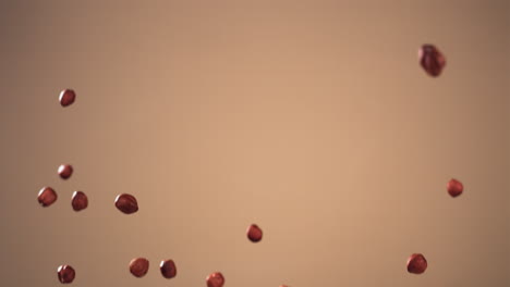 SUPER-SLOW-MOTION-shot-of-peeled-hazelnuts-pile-flying-against-bright-background.-Shot-with-high-speed-video-camera,-420-FPS