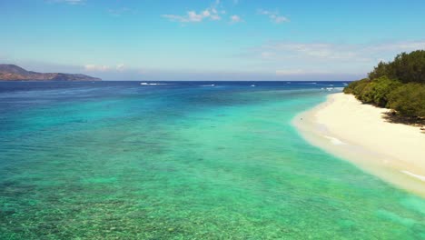 paradise exotic beach of tropical island with white sand washed by blue sea and turquoise lagoon with crystal emerald water in philippines