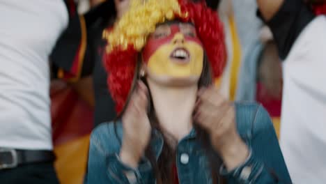 german soccer fan with crowd chanting for her national team