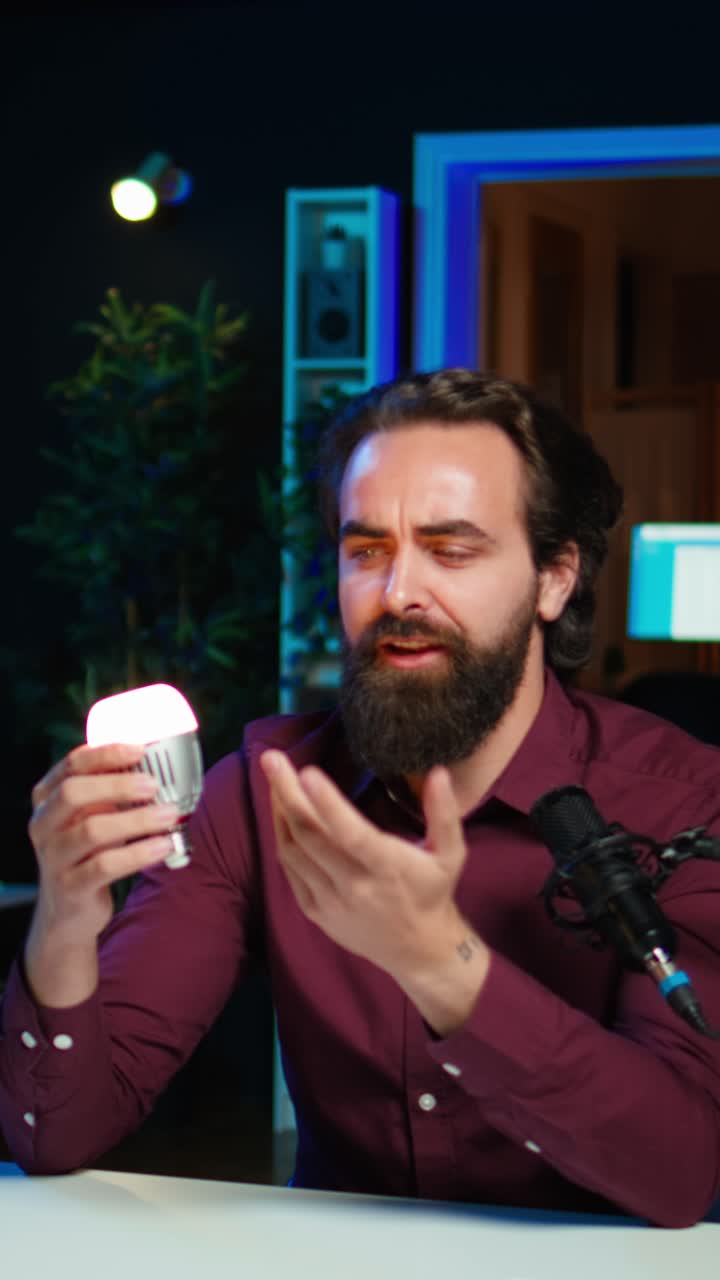 Vertical video Smart light bulb presented by tech specialist in studio