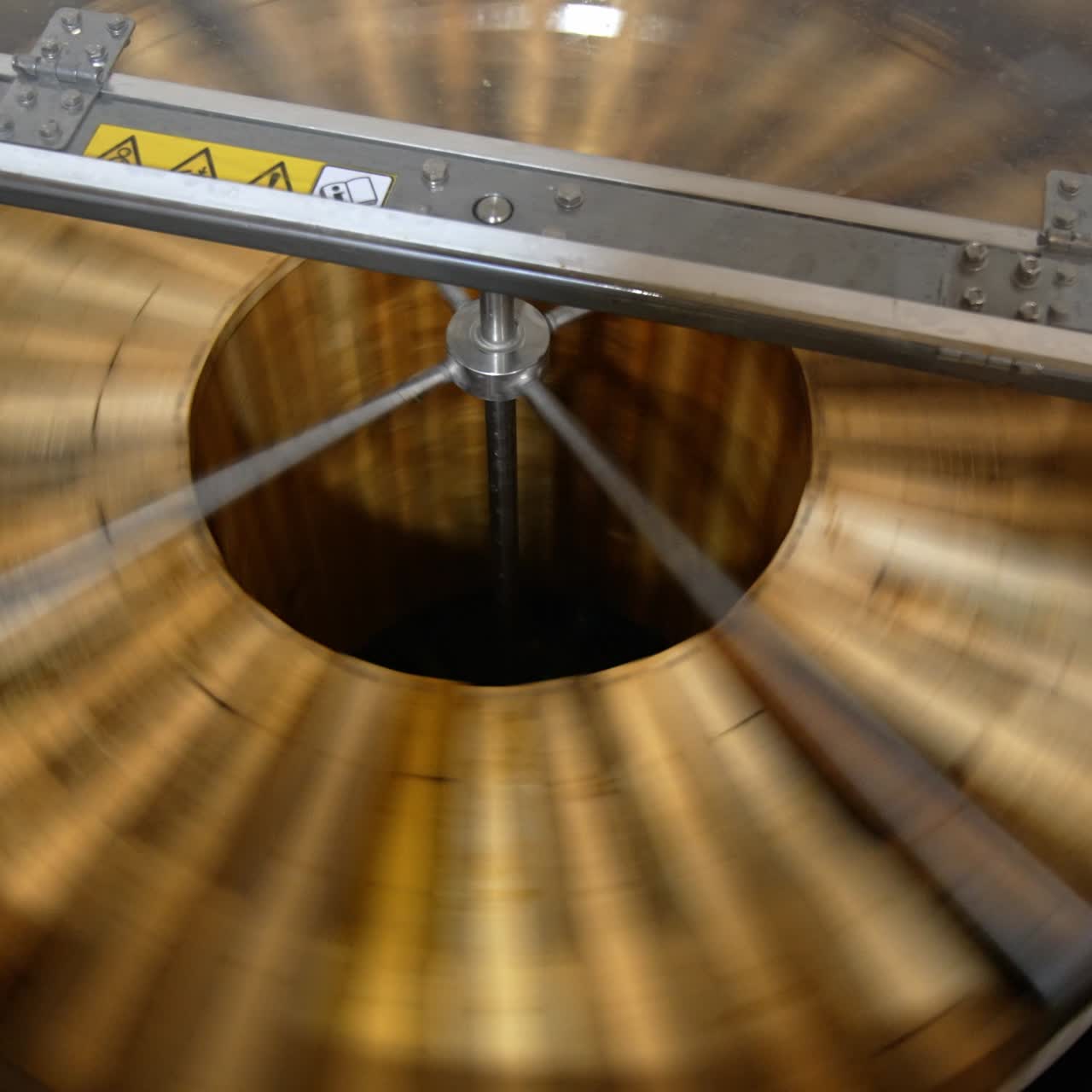 Honey frames rotating inside the machine. Electric equipment for pumping honey at apiary. View from top