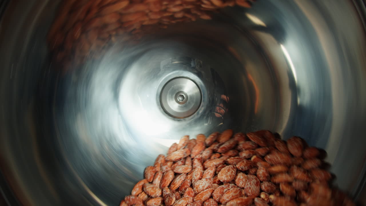 Almonds being processed in a rotating machine
