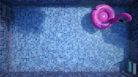 pink flamingo inflatable float in an empty blue swimming pool