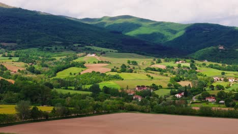 push-in drone aerial view of tuscany’s rolling hills and farmhouses in bibbiena, italy (toscana), capturing the essence of rural charm and nature