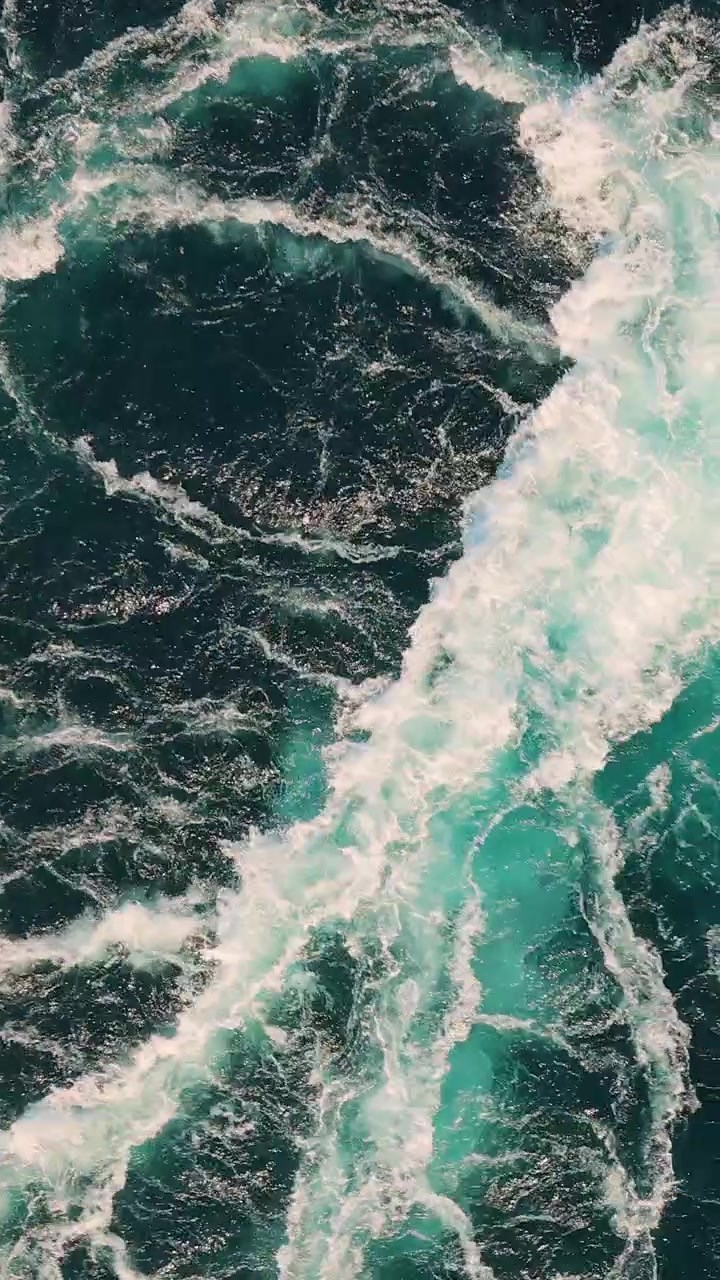 Blue waves of water of the river and the sea meet each other during high tide and low tide.
