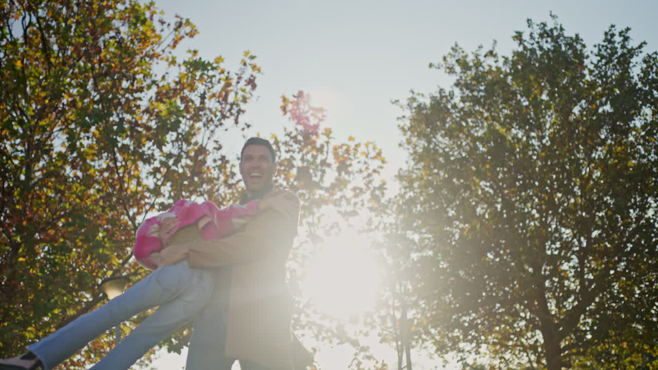 Man carrying woman in the autumn sun
