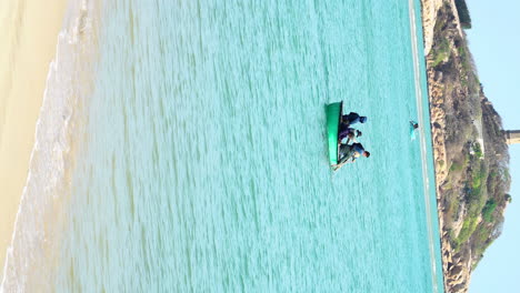 VERTICAL-fisherman-sail-the-river-ocean-water-with-traditional-Vietnamese-boat,-rural-traditional-fishing-family-rowing-in-Vietnamese-sea