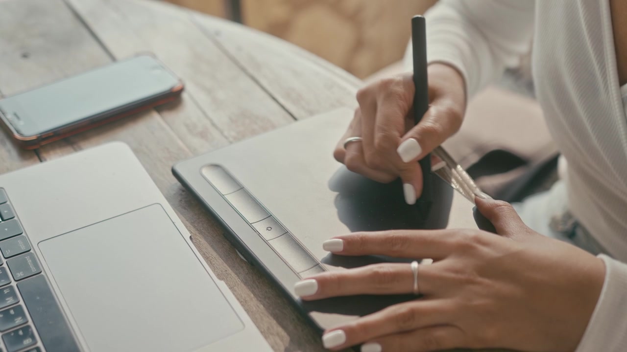 Graphic Designer Using Digital Pen Tablet at Desk