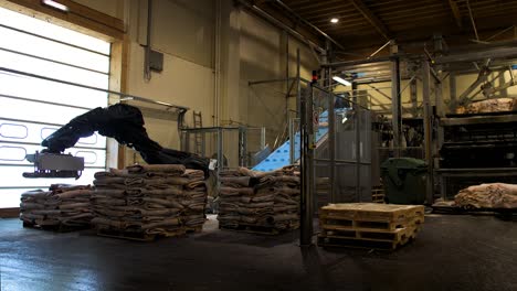 arm machine moving  leather sheets inside a factory