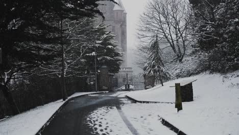 light snowfall outside gates of belfast castle, slow motion