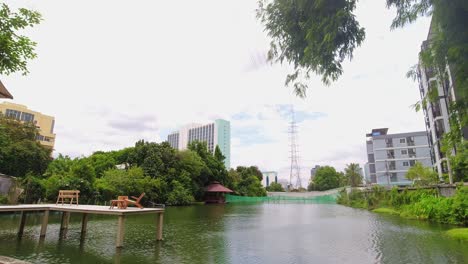 beautiful lake in the city of bangkok at a cafe with a wooden platform with seating