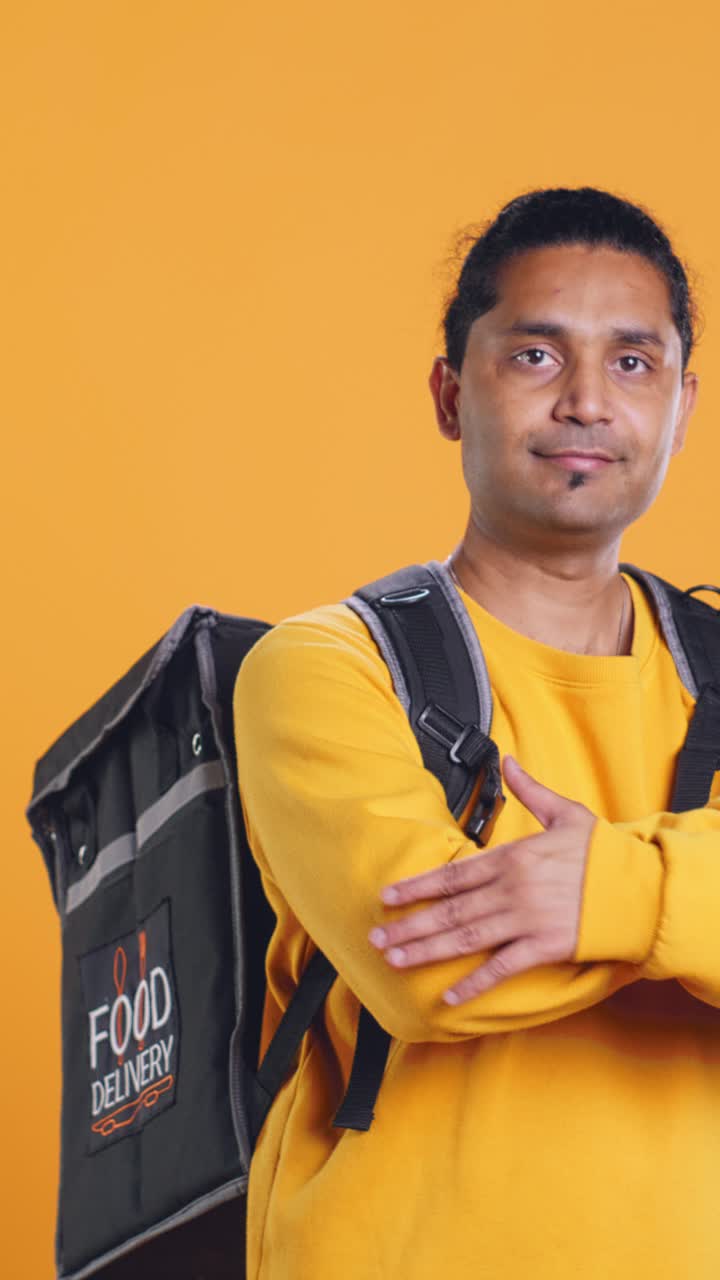 Confident Food Delivery Man with Backpack Posing in Studio