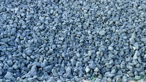 large pebbles laid on railway tracks, speed railway, small pieces of rock used in construction,