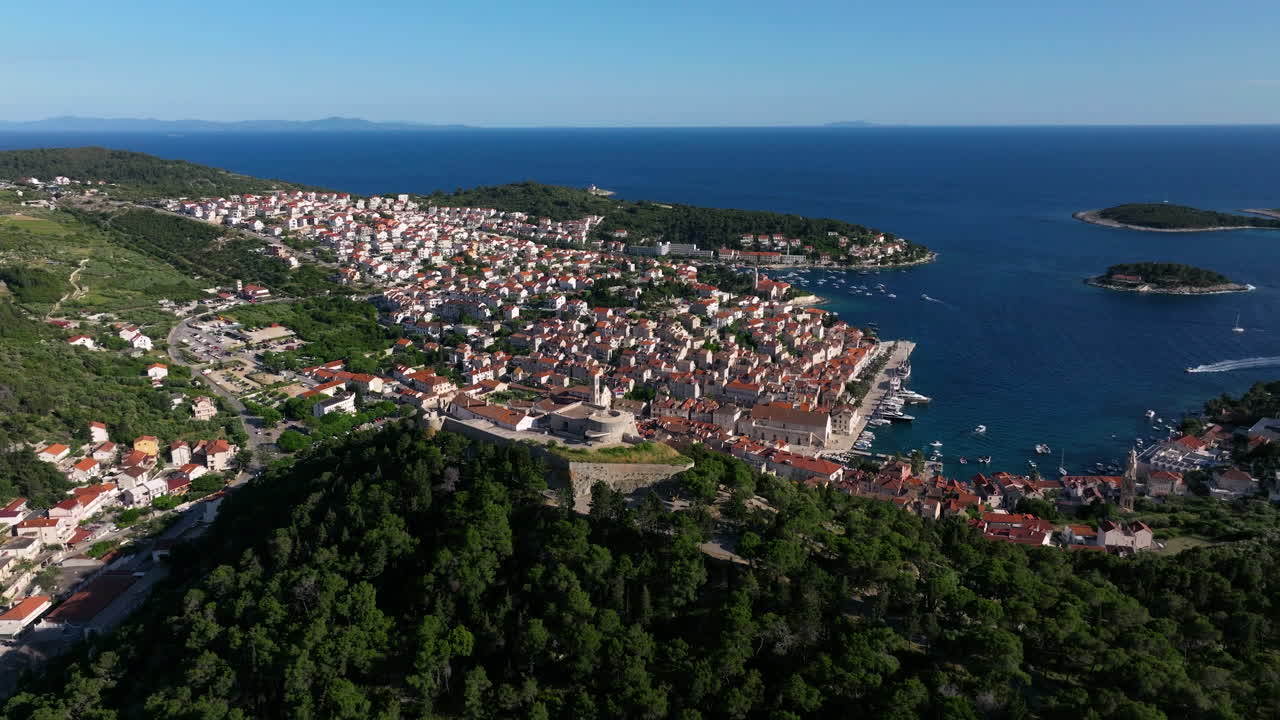 Fortica Fortress Overlooking The Adriatic Sea, Islands And Hvar Old Town Houses In Croatia. - aerial shot