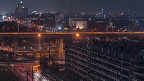 night traffic in bangkok city with cityscape in the background. timelapse from maple hotel