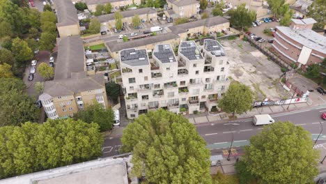 aerial showcase of contemporary apartment complex with geometric architecture, peckham rye, london, uk, october 2024