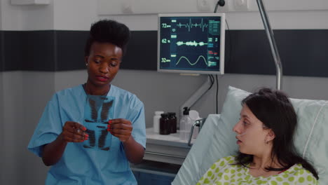 Closeup-of-nurse-with-black-skin-analyzing-bones-radiography