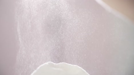 powder spraying into bowl
