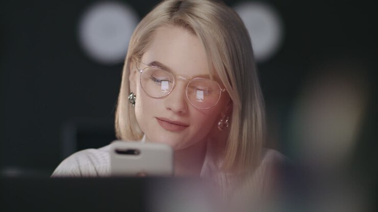 Happy business woman typing message on mobile phone