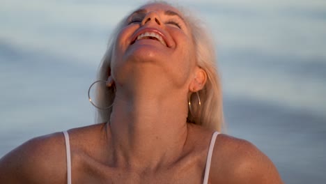 Extreme-closeup-of-mature-woman-flirting-with-camera-with-ocean-behind-her