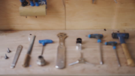 close up of carpentry tools on workbench in workshop pulled into focus