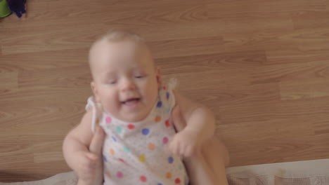 mum playing with baby daughter and kissing her