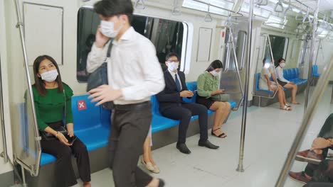 woman stops man from sitting next to her on train for social distancing .