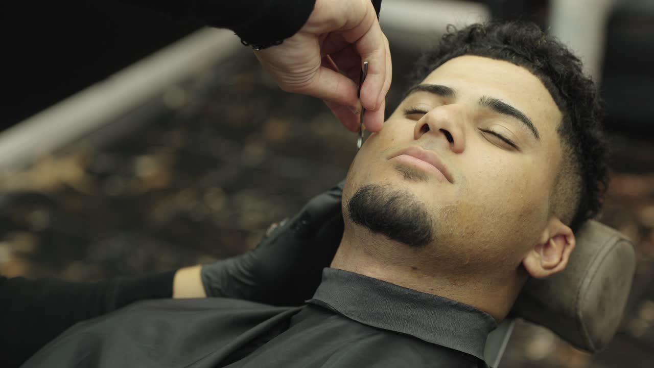 Man getting a shave at the barbershop