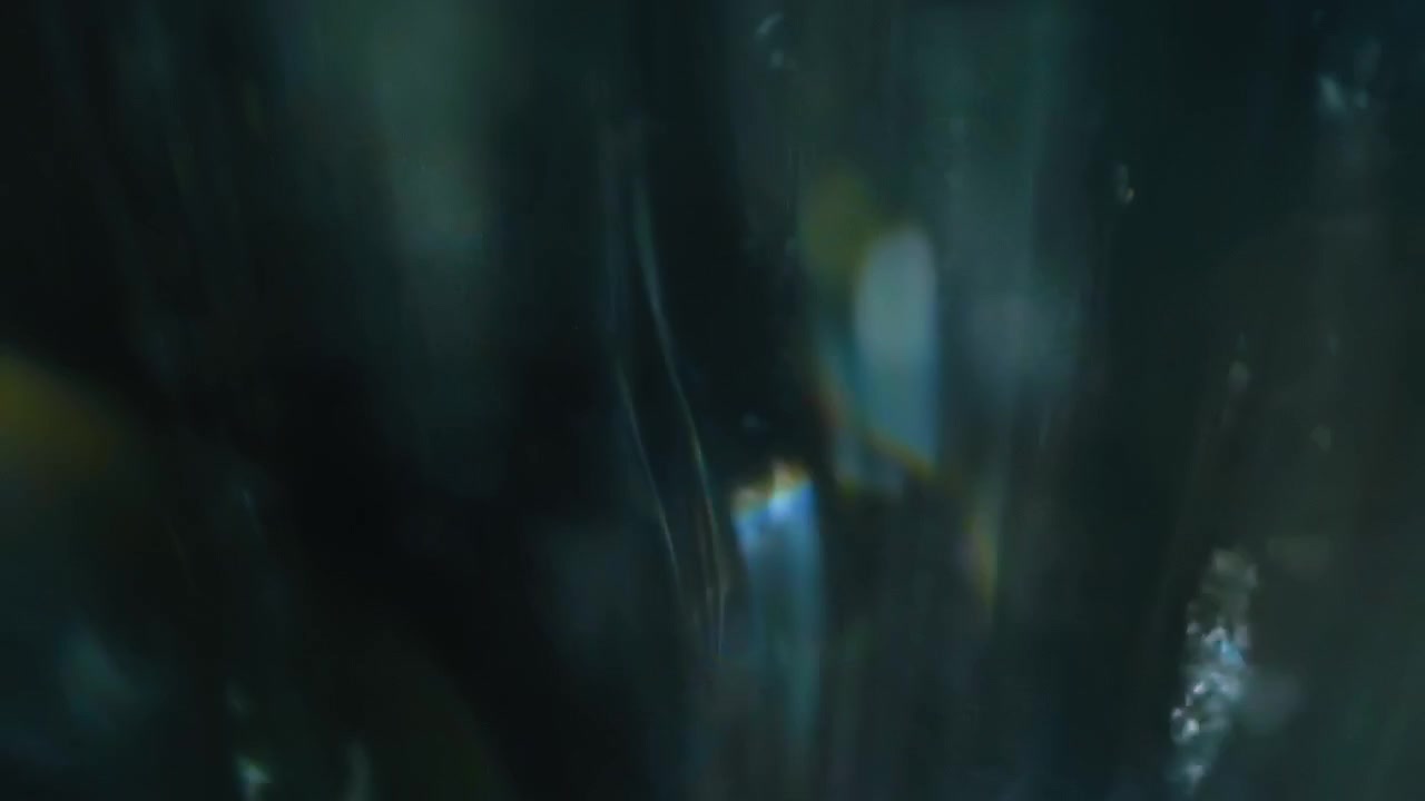 fresh clear water drops fall down on dark background