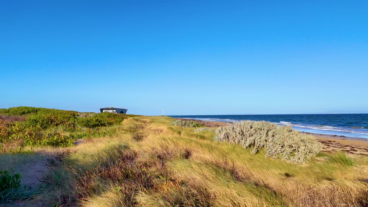 Aerial footage of Bellarine Peninsula's coastal scenery with lush greenery and ocean views under clear blue skies