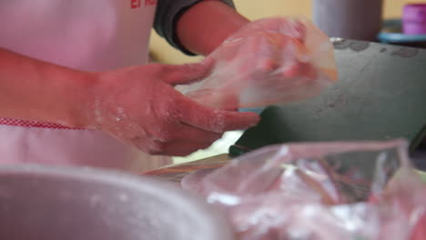 Close-up-of-a-woman-making-fresh-tortillas-using-a-hand-press-in-Mexico