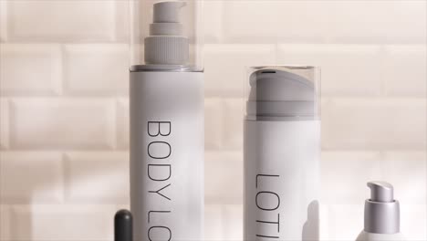 Close-up-of-skincare-bottles-in-3D-animation,-showcasing-modern-design-with-clean-lines-and-transparent-materials-on-a-reflective-surface.