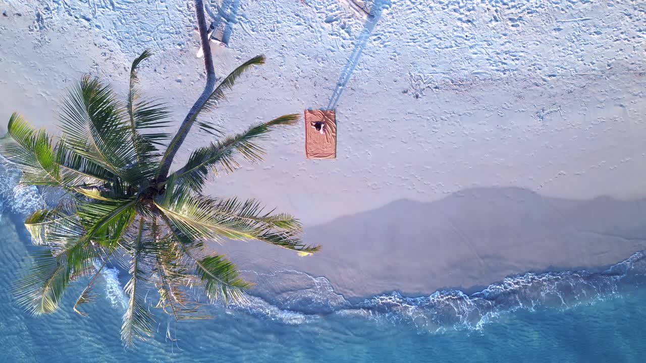 женщина делает упражнение йоги на пляже на береговой линии