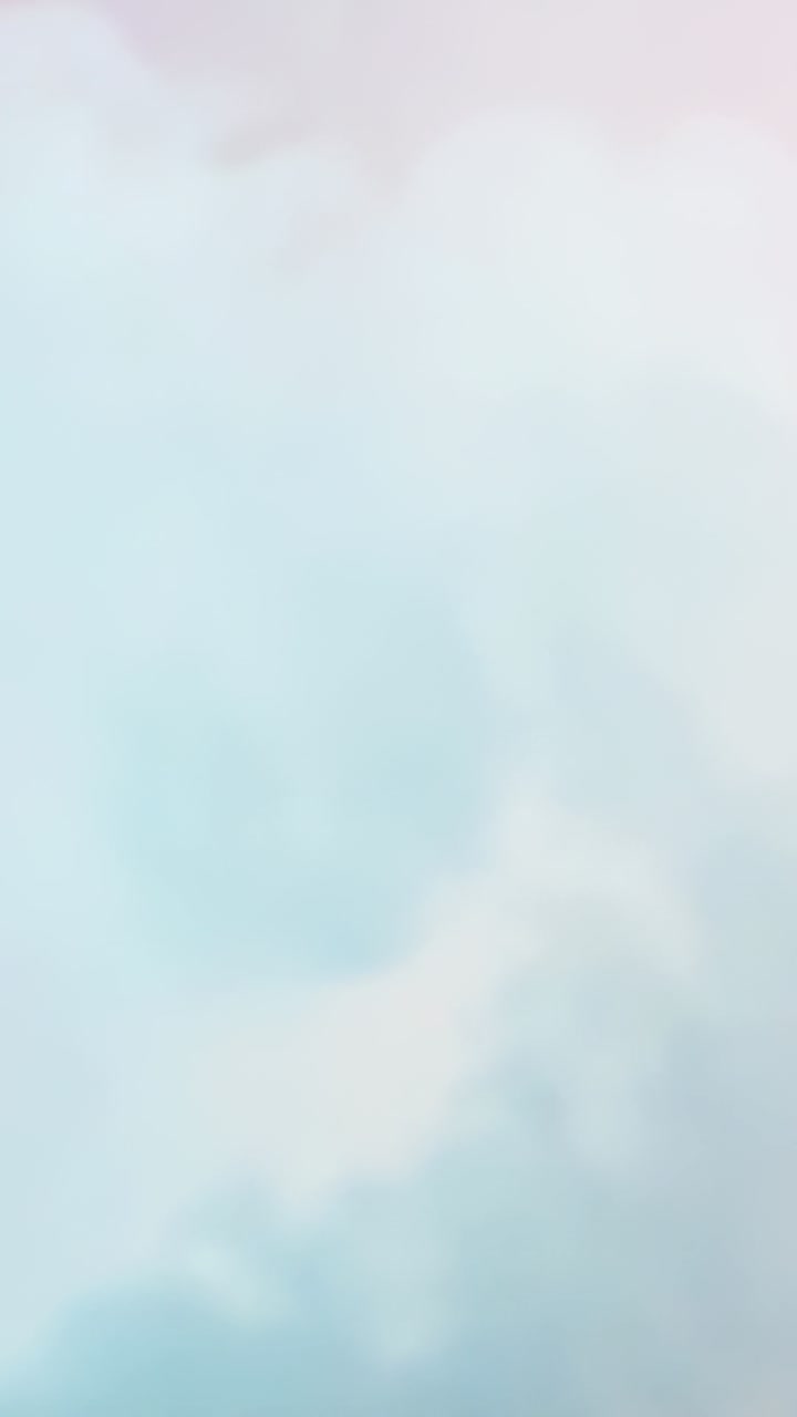 Vertical video: Shifting pastel wash blending peach into blue in studio on loop forming calm hue