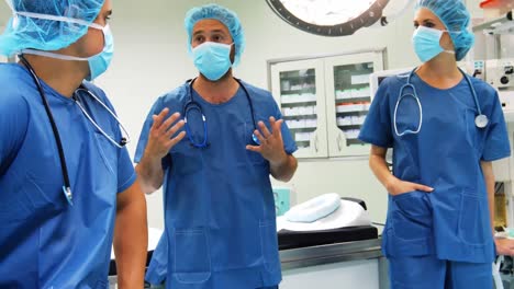 male and female surgeons interacting with each other in operation room