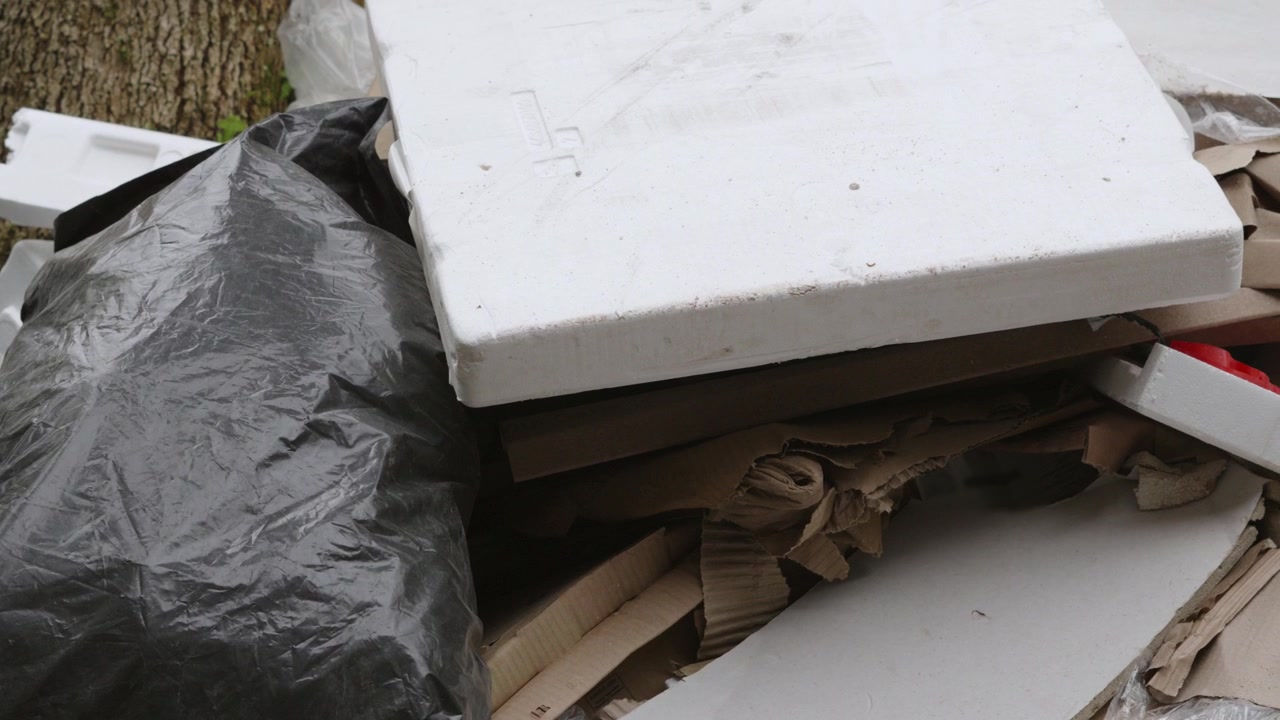 Pan Across Huge Mound of Fly Tipped Waste with Black Garbage Bags and Polystyrene Plastic. Polluting Natural Environment in UK. 4K.