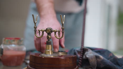 man artist presses buttons to make call. professional painter shifts focus to retro phone to find new live model for future women portraits in studio