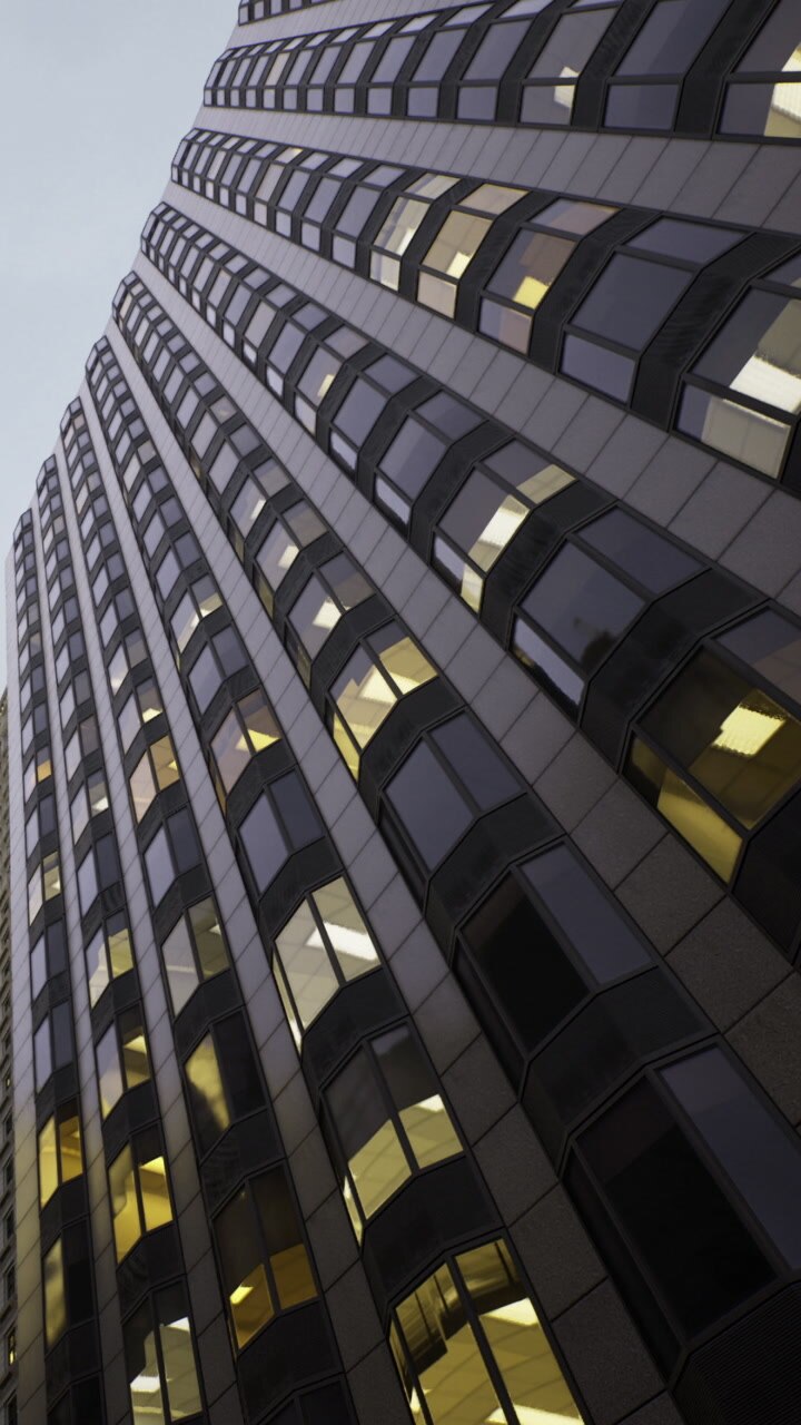 Office building with windows reflecting city skyline in evening light