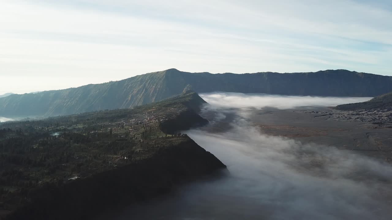 Beautiful view of Mount Bromo National Park in the morning with thin mist covering the area.