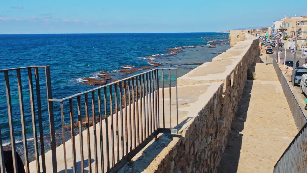Ancient stone city walls meeting the mediterranean sea in akko, israel