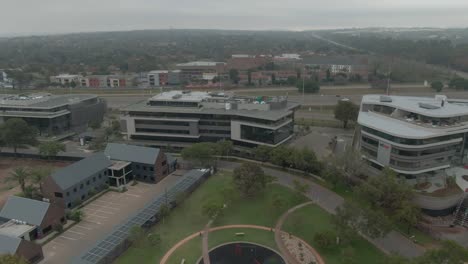 Drone-aerial-of-newly-built-office-blocks-with-green-parks