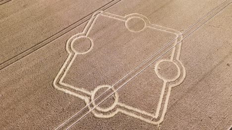 crop circle, symmetric geometric figure pattern in wheat field, mysterious signs