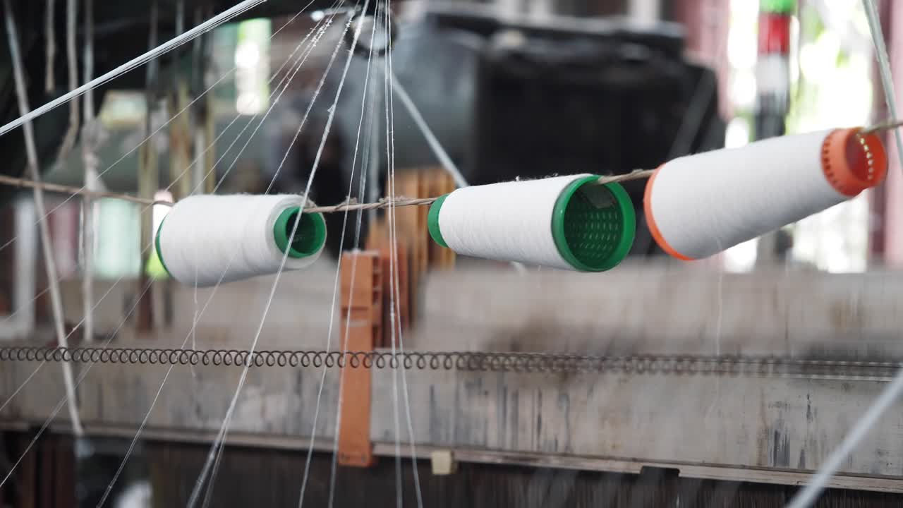 Close-up of textile loom with threads